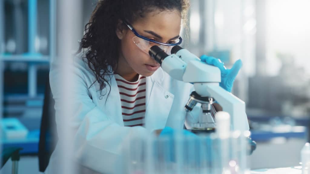 Medical Science Laboratory: Portrait Of Beautiful Black Scientist Looking Under
