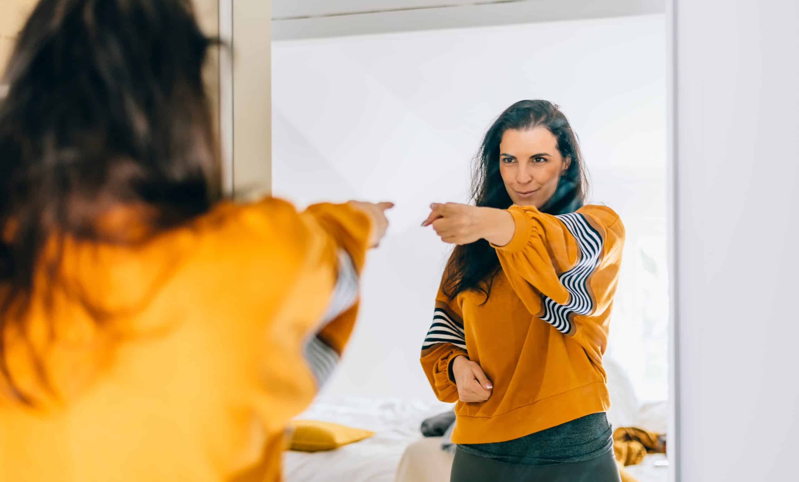 Self Confident Single Woman Pointing Finger At Her Reflection In