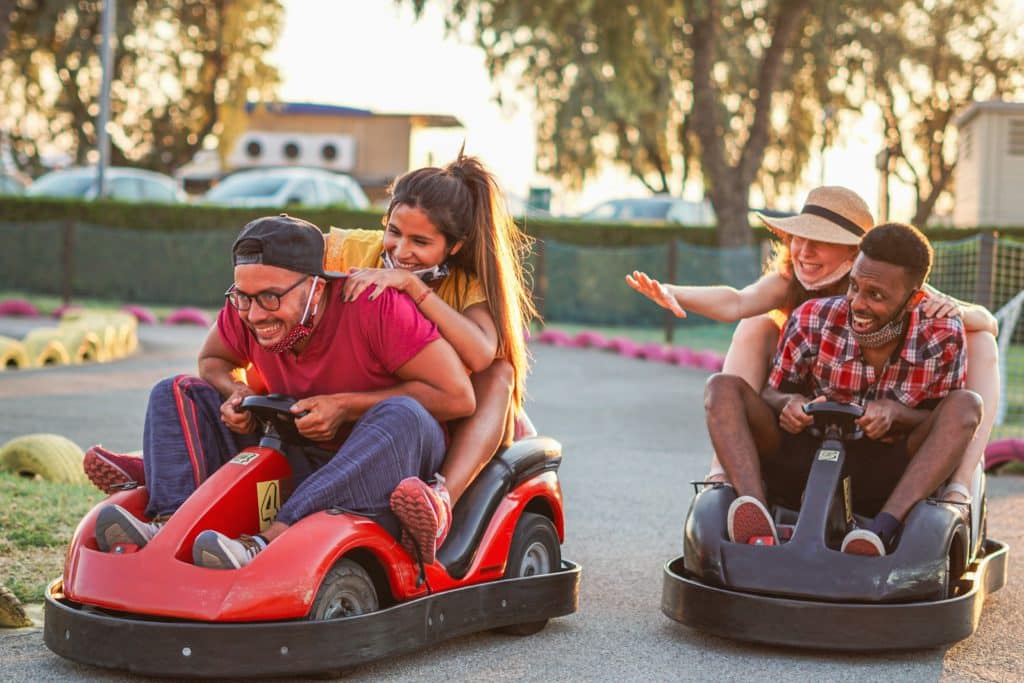 Group Of Multiracial Friends Having Fun With Go Kart 