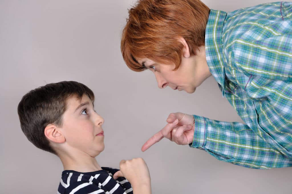 Woman Scolding And Pointing Her Index Finger At The Scared