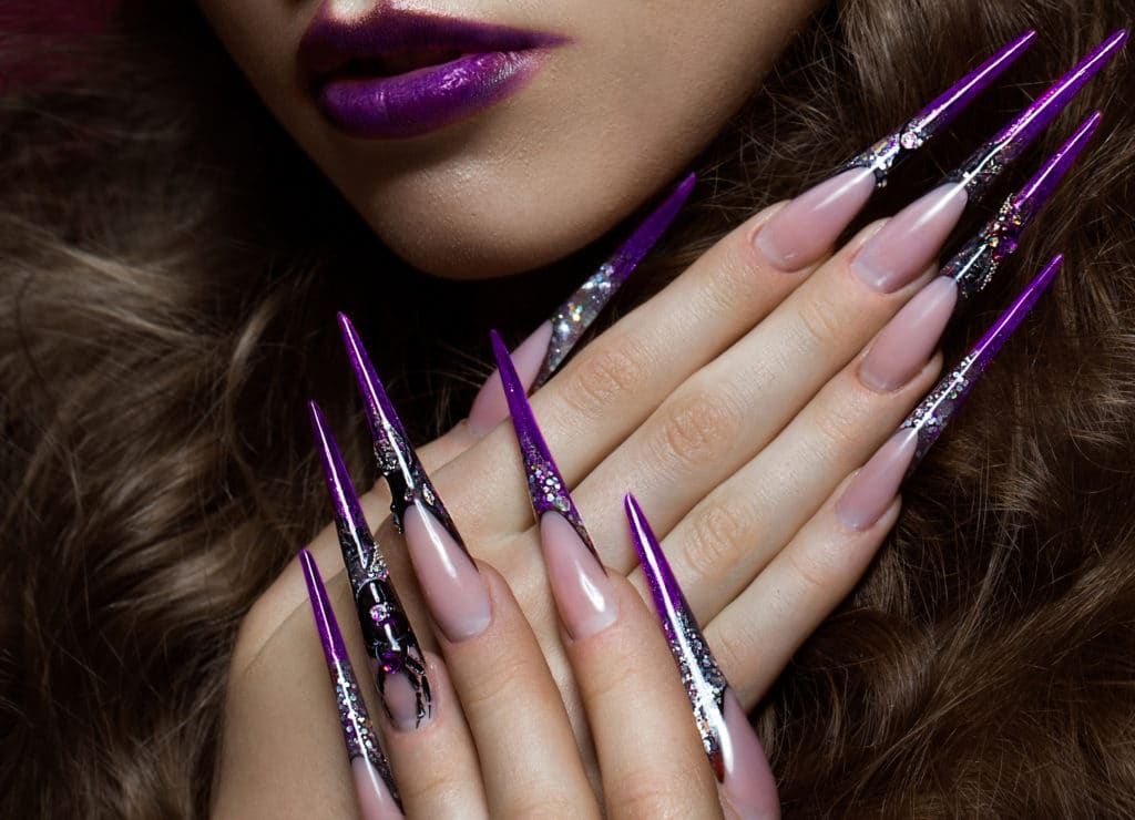 Portrait Of Woman With Creative Art Makeup And Long Nails.