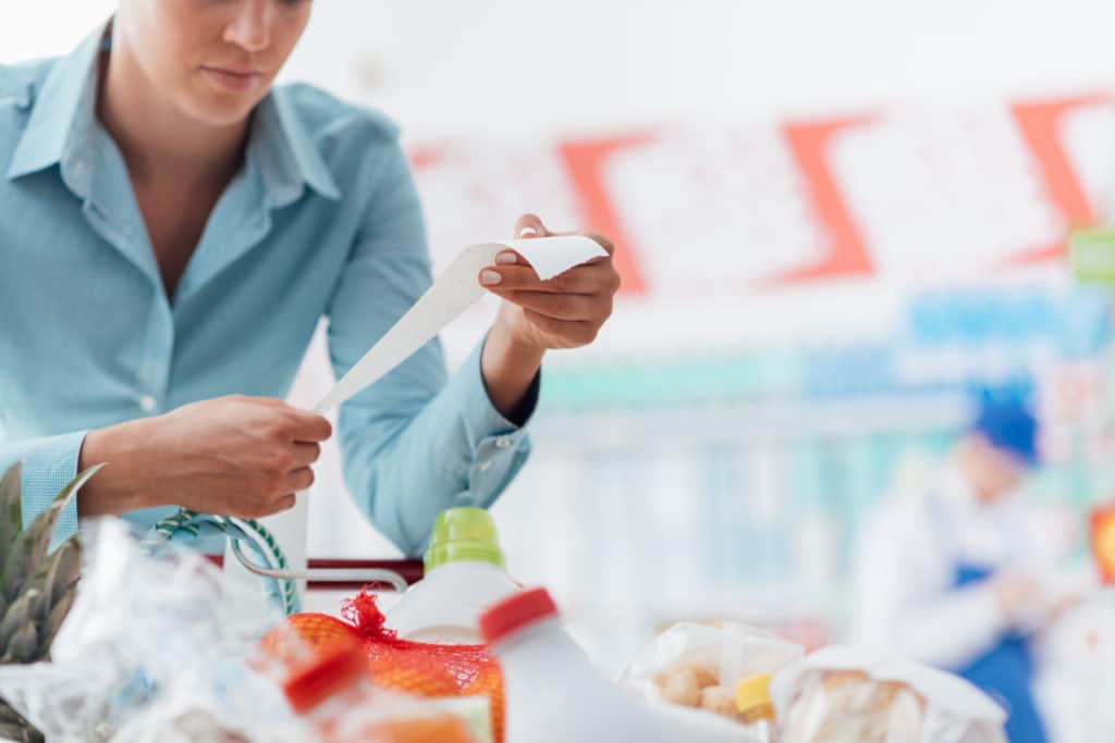 Woman Shopping At The Supermarket She Is Checking A Long