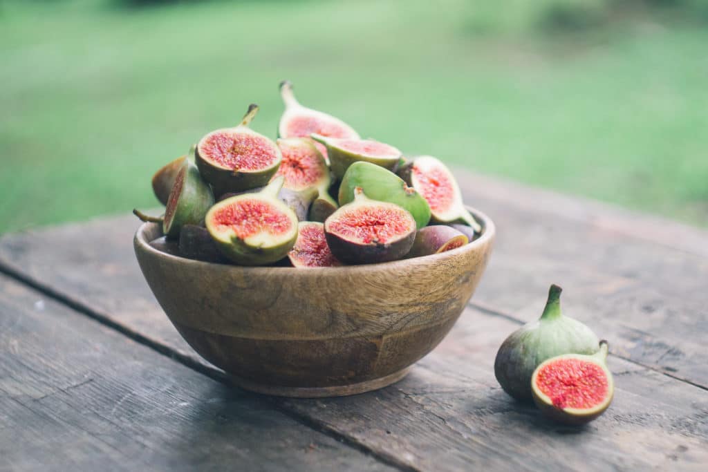 Fresh Red Figs Bowl On The Wooden Background.
