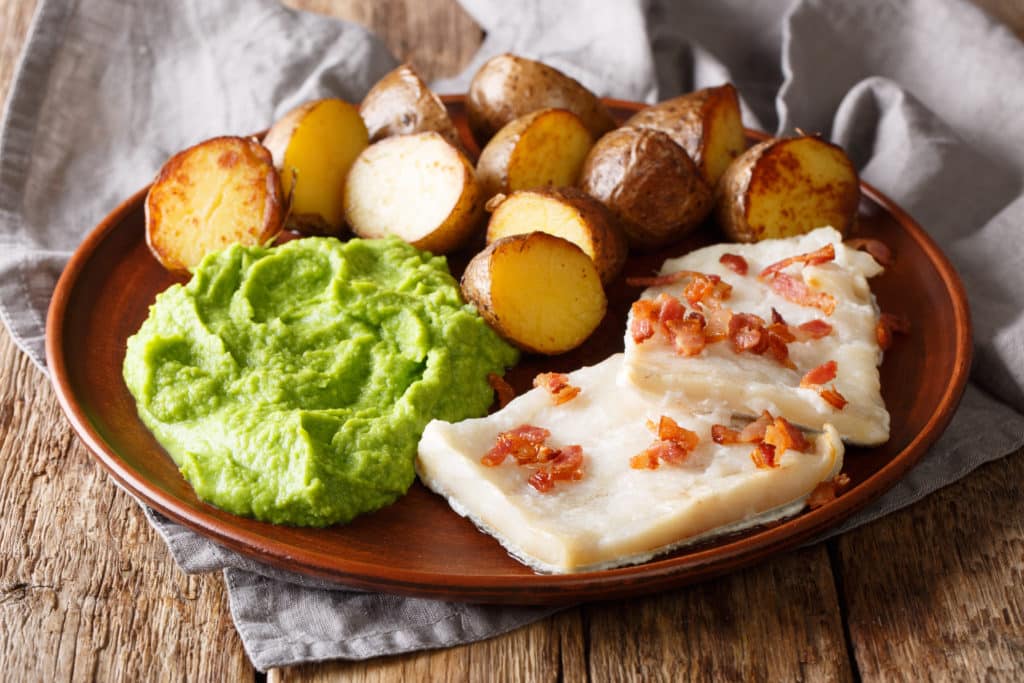 Traditional Scandinavian Dish Lutefisk Served With Pea Puree Potatoes And