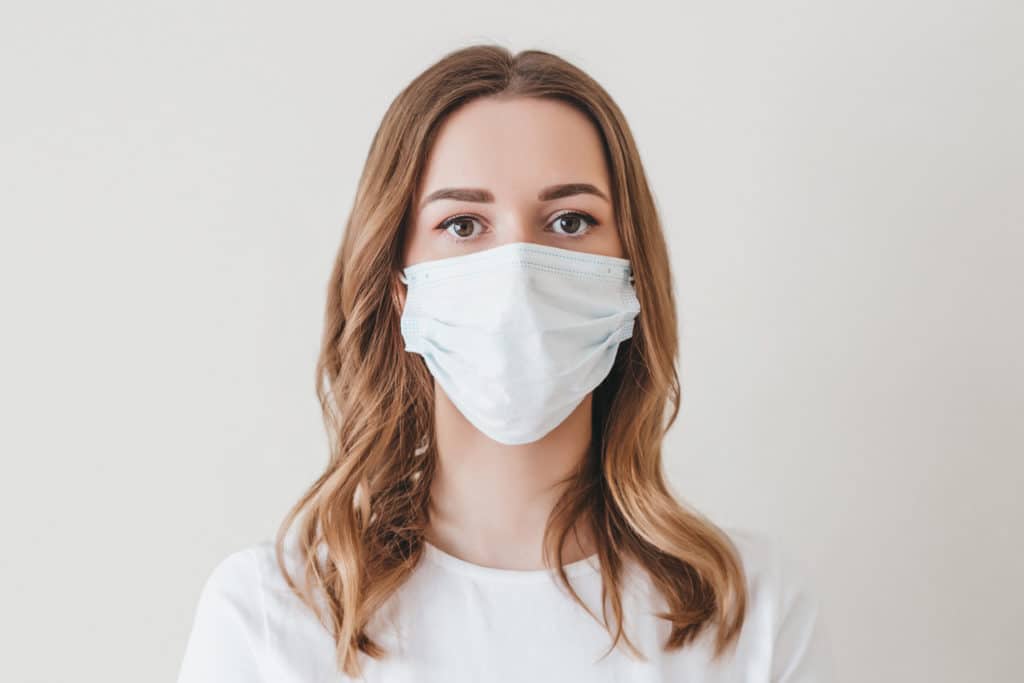 Portrait Of A Young Girl In A Medical Mask Isolated