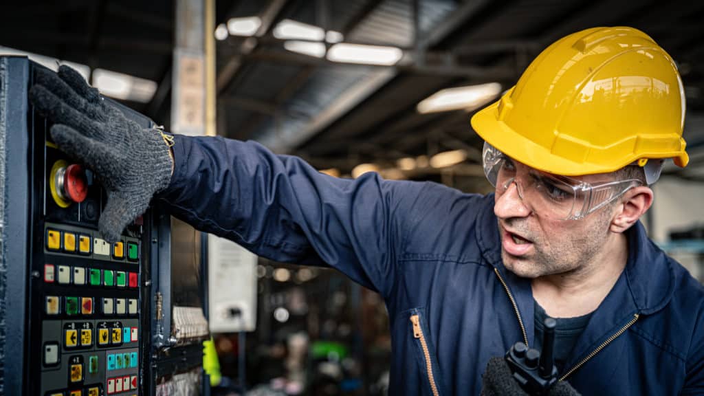 Factory Worker Quickly Pushing Red Button To Emergency Turn Off