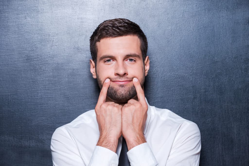 Put On Your Smile! Handsome Young Man In Formalwear Holding