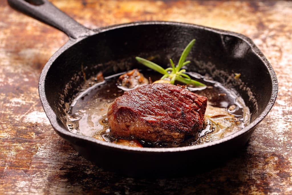 Beef Steak On Cast Iron Skillet With Empty Space For