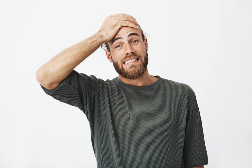 Beautiful Bearded Man Holding Hand On Forehead With Frightened Expression