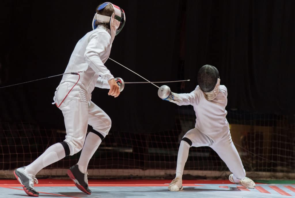 Two Man Fencing Athletes Fight On Professional Sports Arena