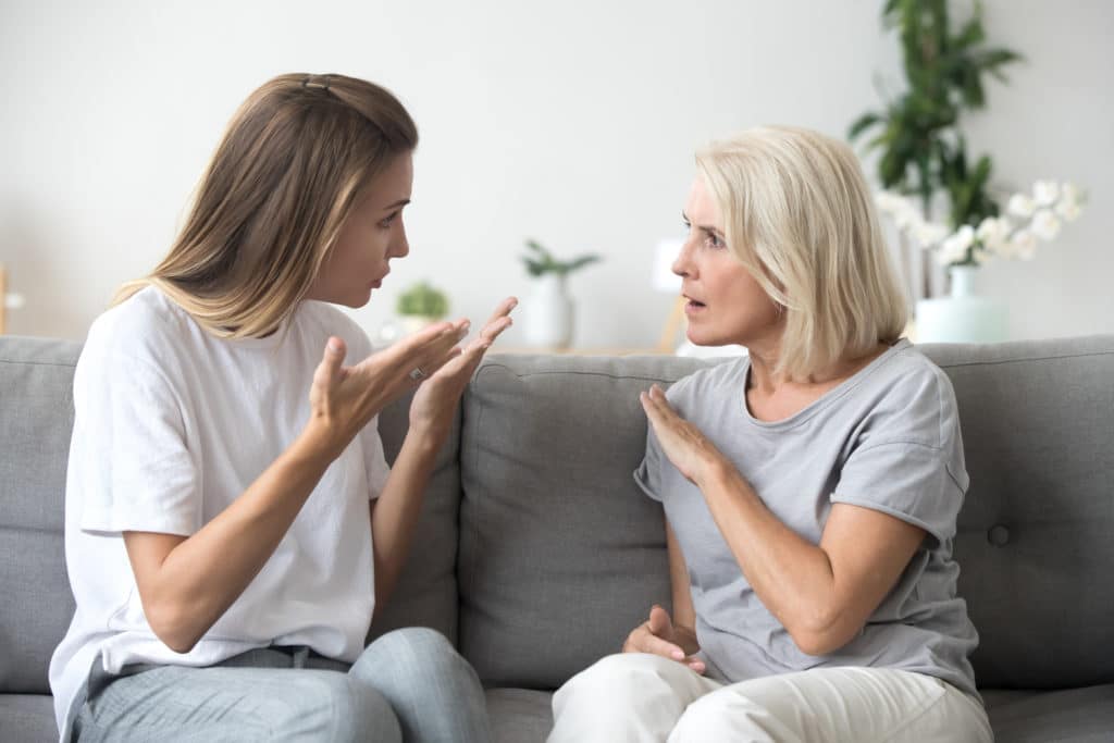 Angry Young Woman Has Disagreement With Annoyed Old Mother In