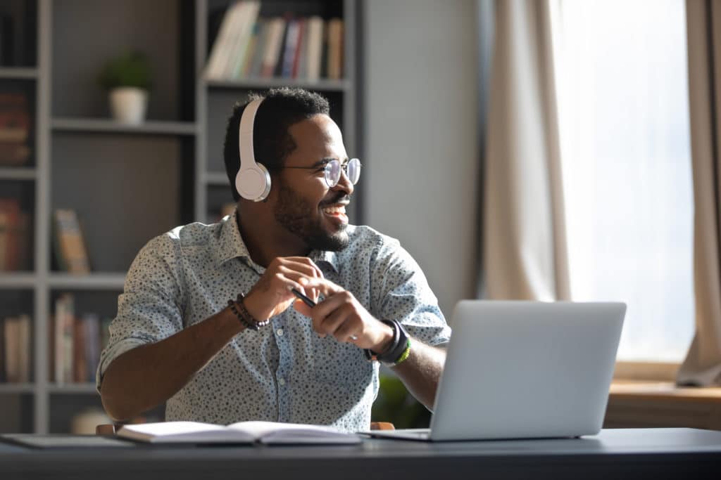 Happy Relaxed Millennial Afro American Business Man Wear Wireless Headphones