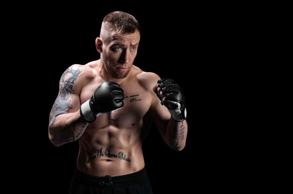 Mixed Martial Artist Posing On A Black Background. Concept Of