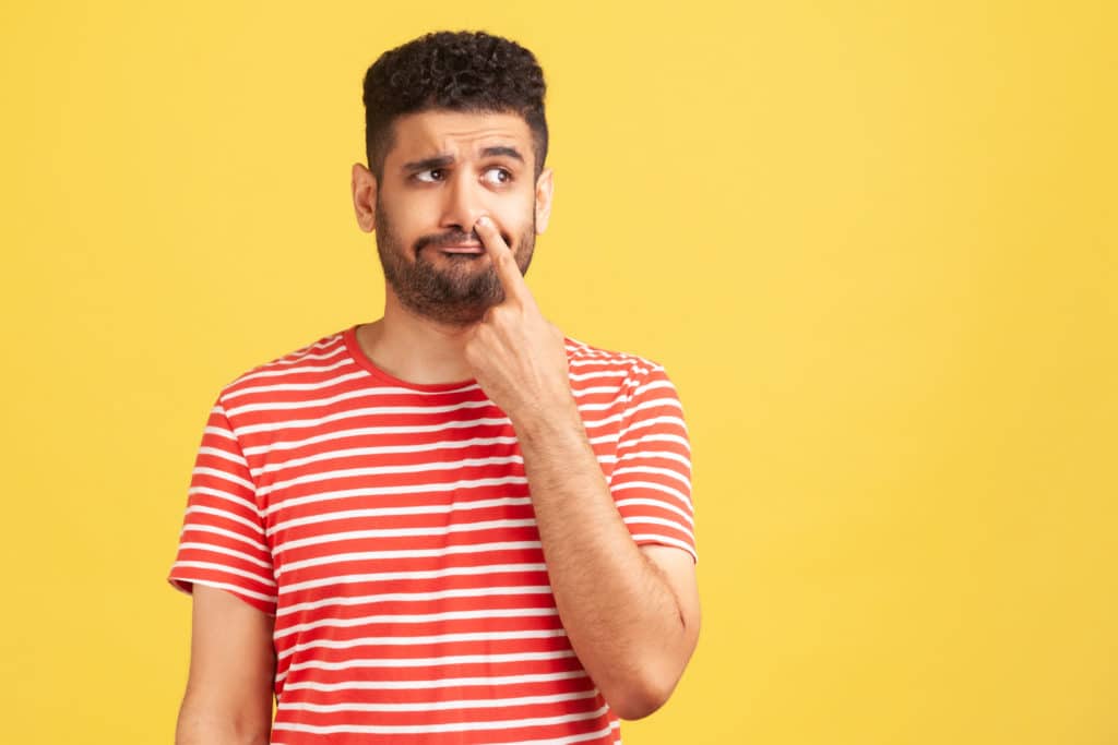 Uncultured Bored Bearded Man In Red Striped T Shirt Putting Finger