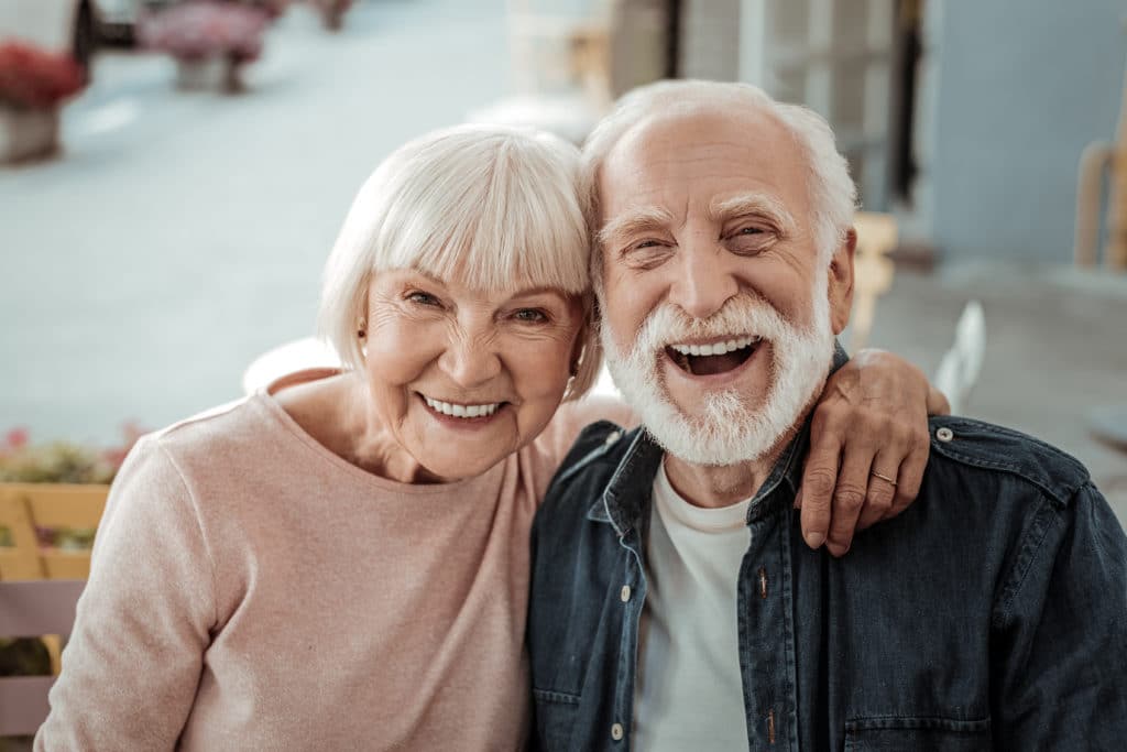 Elderly Couple. Joyful Nice Elderly Couple Smiling While Being In