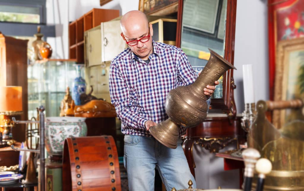 Interested Mature Man Collector Of Vintage Goods Choosing Ancient Things