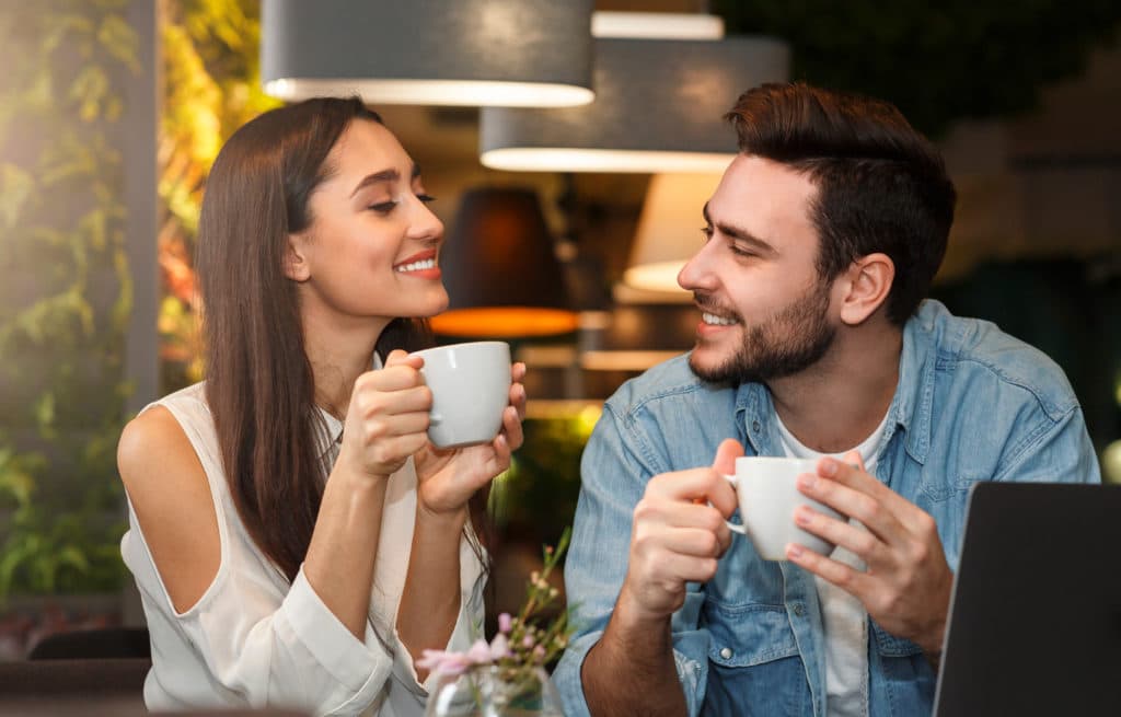 Dating. Young Couple Tasting Coffee Drinks Enjoying Flirt And Conversation