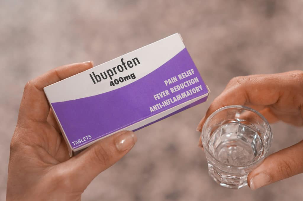 Woman Hold A Box Of 400mg Ibuprofen Tablets In Her