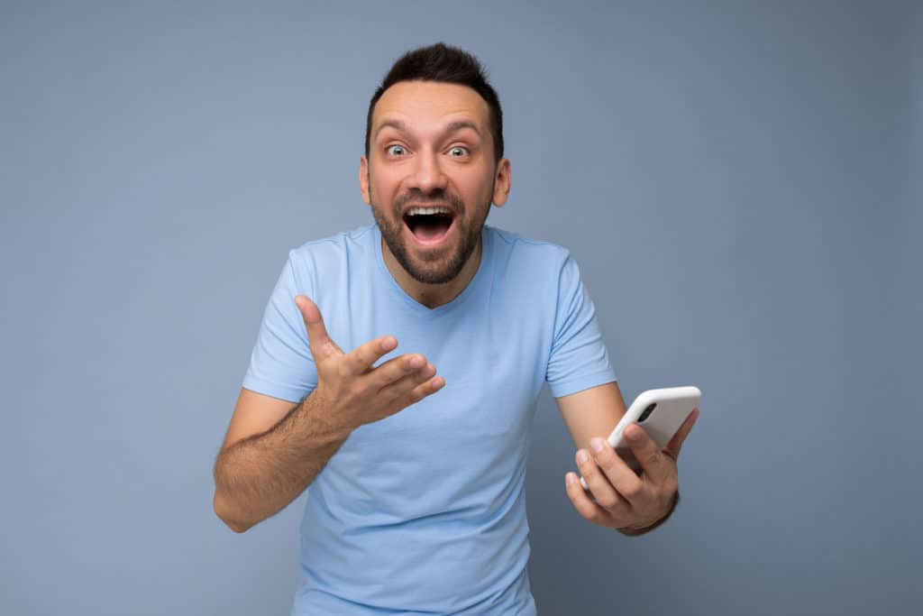 Shocked Handsome Young Bearded Man Wearing Everyday Blue T Shirt Isolated