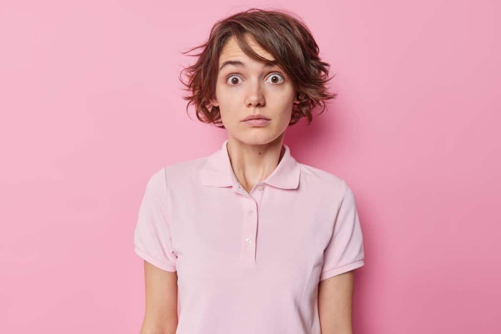 Shocked Embarrassed Woman With Short Hairstyle Stares Bugged Eyes Feels