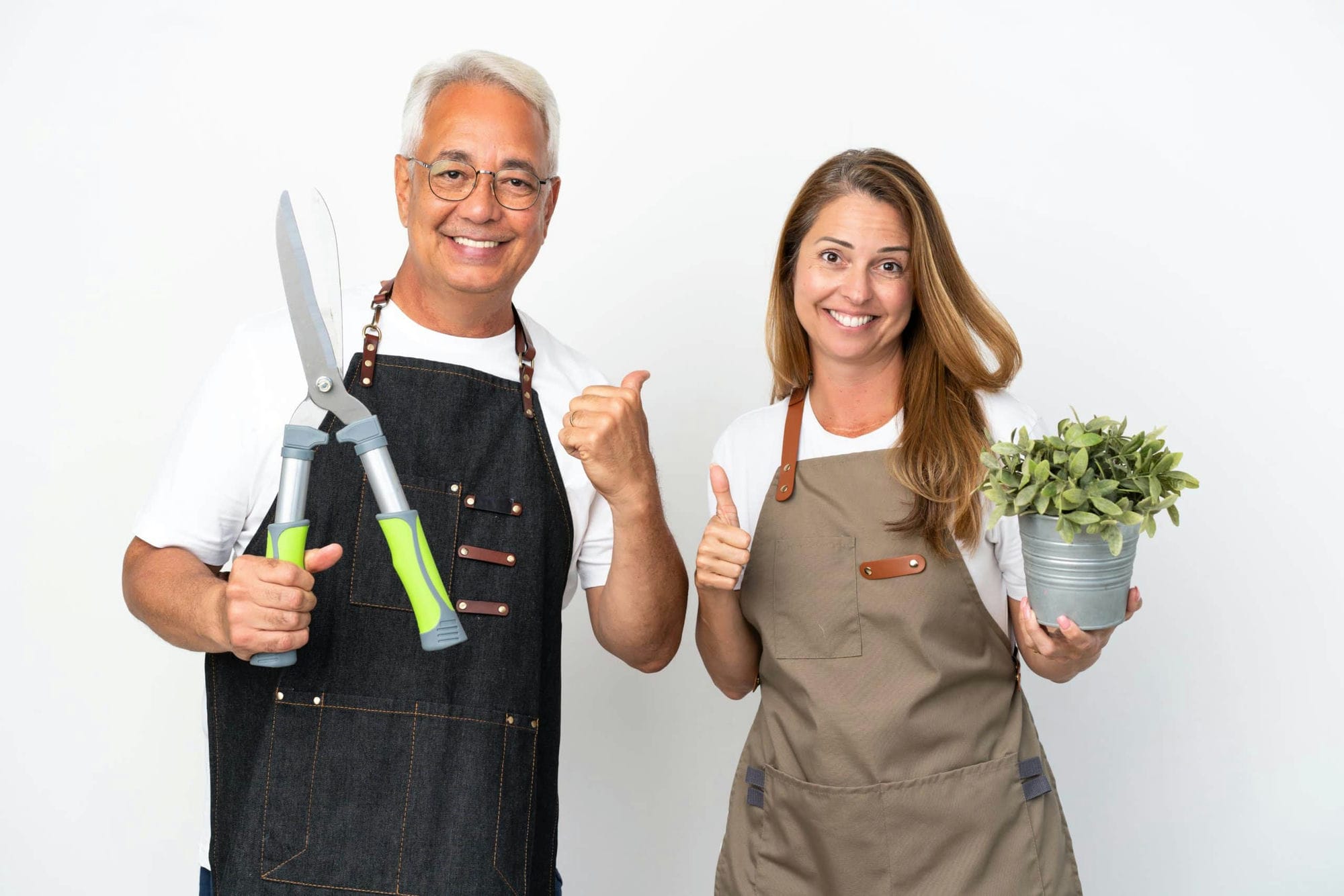 Middle Age Gardeners Holding A Plant And Scissors Isolated On