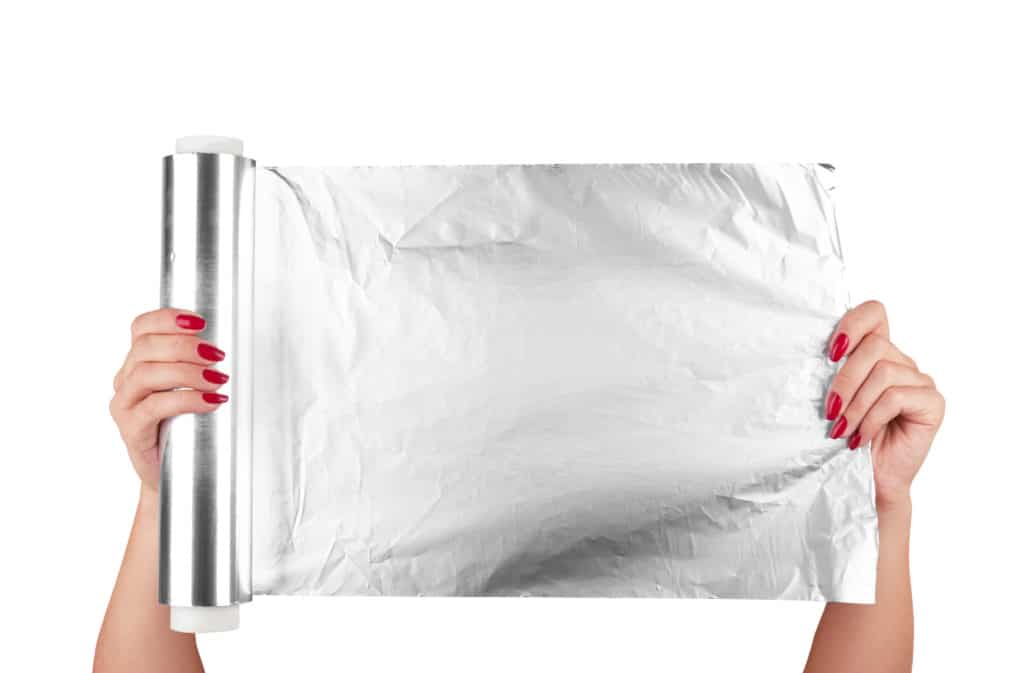 Woman Holding A Roll Of Aluminum Foil