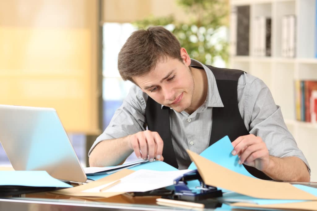 Incompetent Messy Businessman With Disorganized Desk Searching Lost Documents At