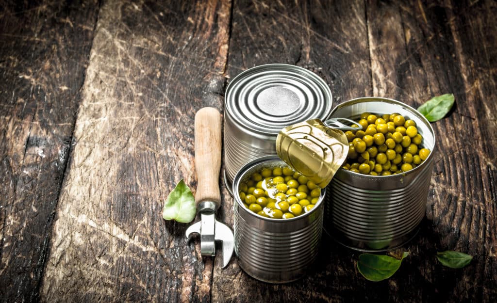 Canned Green Peas In A Tin Can With Opener. On