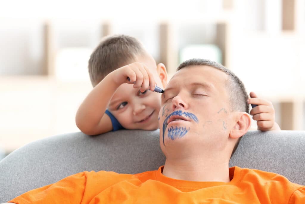 Little Boy Painting His Father's Face While He Sleeping. April