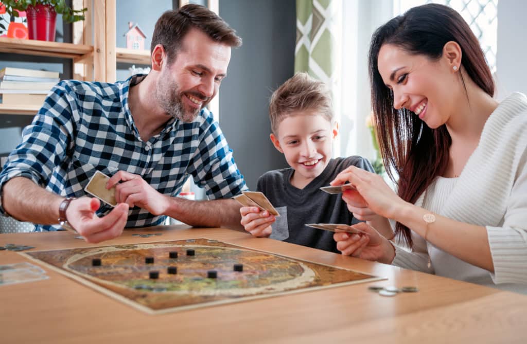 Happy Family Playing Board Game At Home Happiness Concept