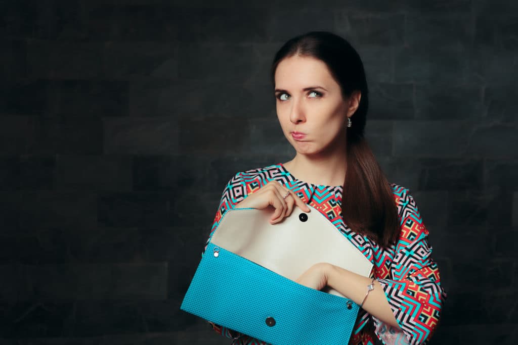 Unhappy Fancy Woman Checking Inside Empty Bag . Exigent Fashion