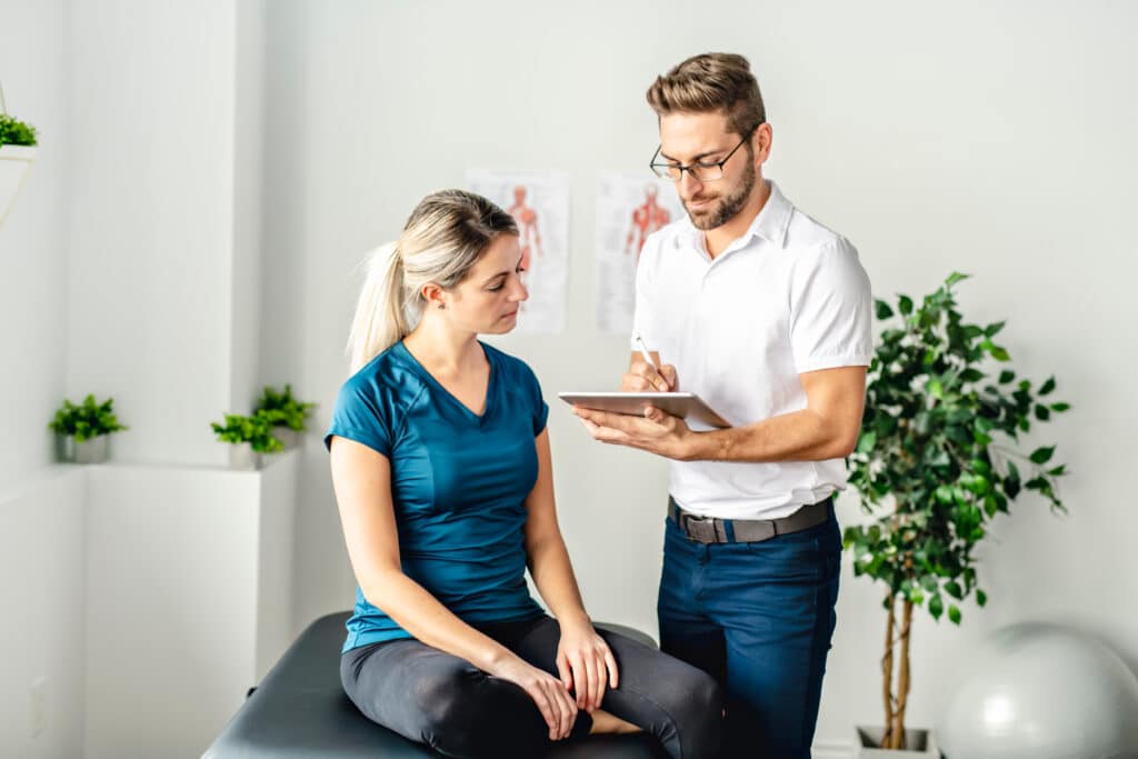 A Modern Rehabilitation Physiotherapy Man At Work With Woman Client