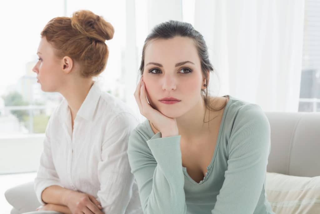 Unhappy Young Female Friends Not Talking After Argument At Home