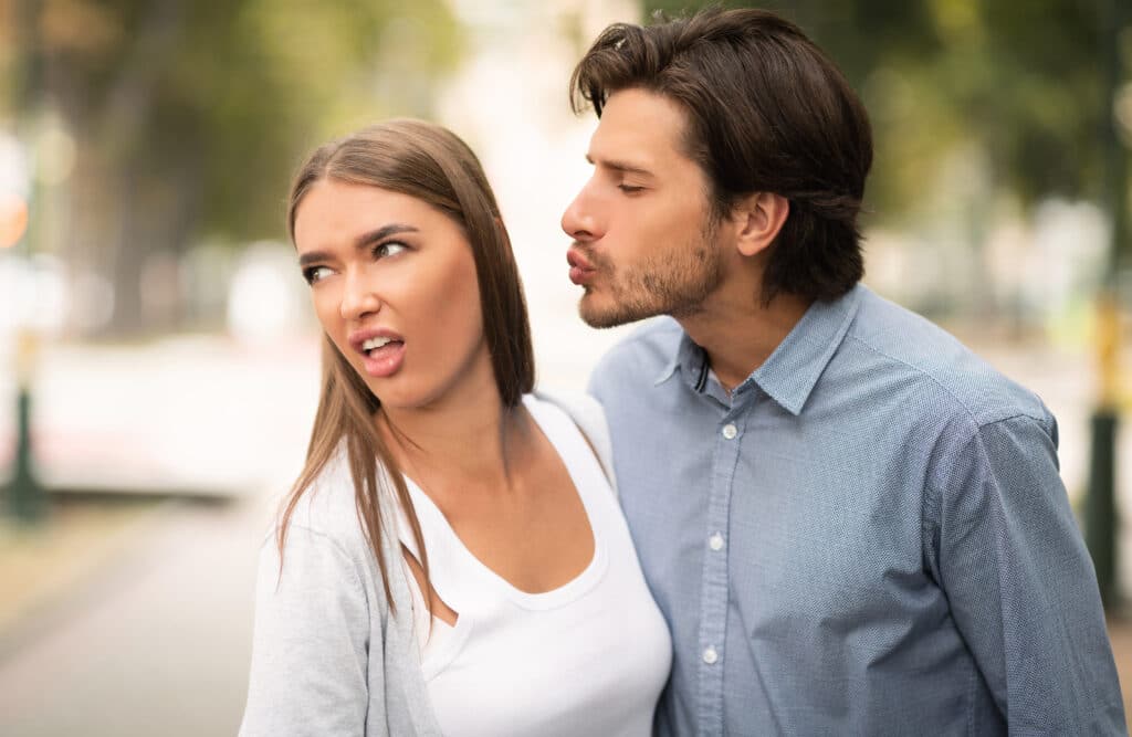 Disgusted Woman Rejecting To Kiss Man Having Bad Date Walking