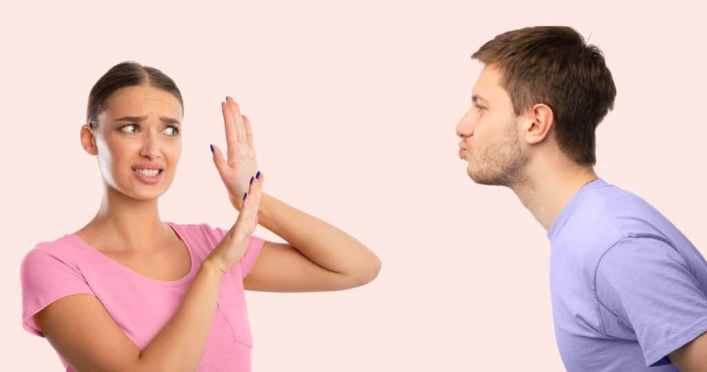 Friendzone Concept. Disgusted Woman Avoiding Unwanted Kiss From Obsessed Man