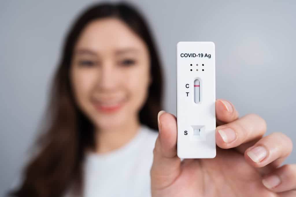 Happy Woman Holding Coronavirus(covid 19) Negative Test Result With Antigen Rapid