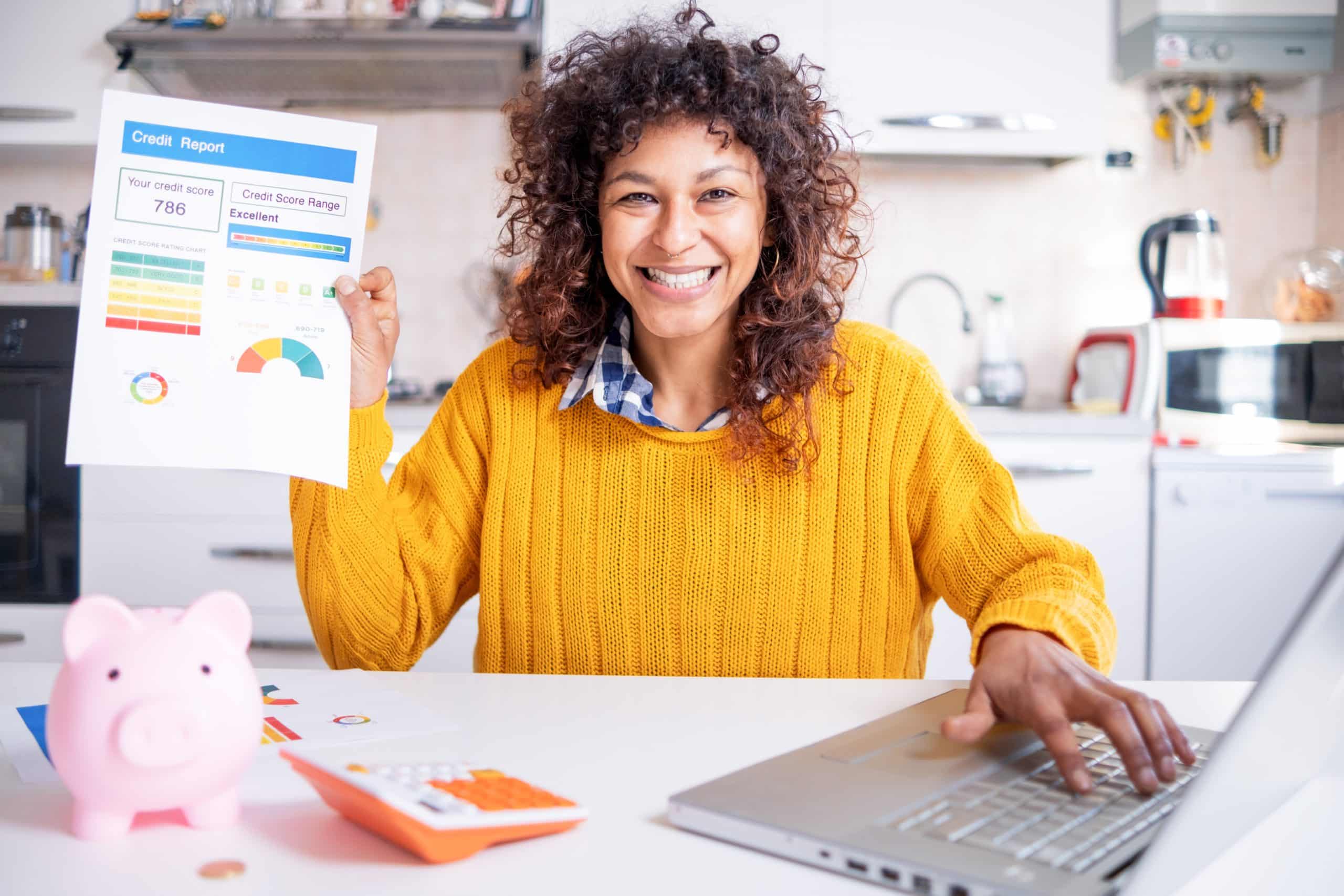Happy Black Woman Checking Her Good Credit Score Online