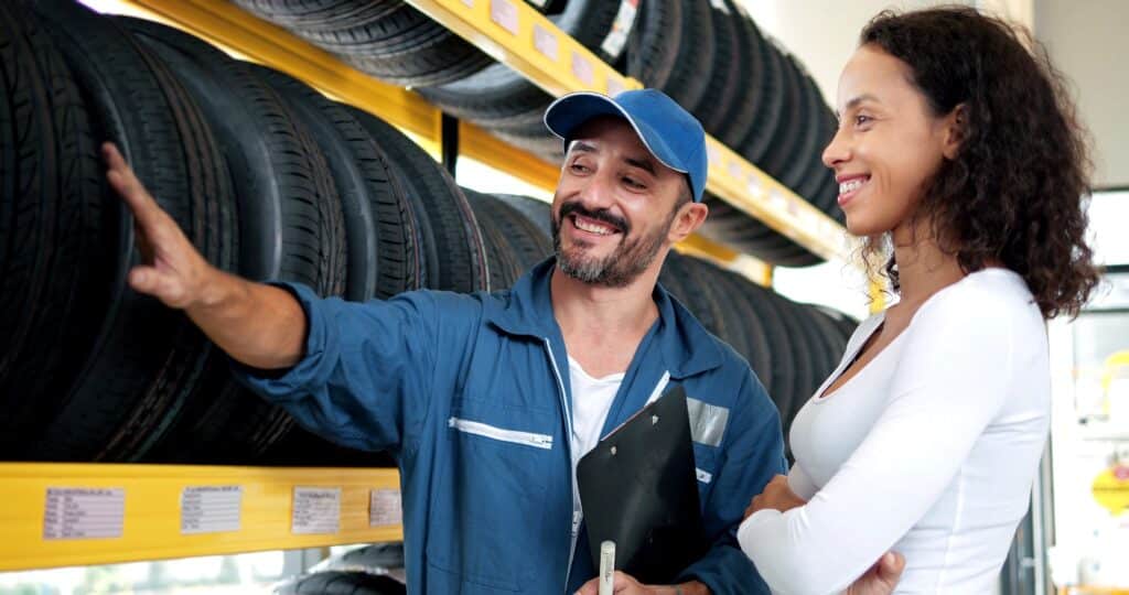 Salesman Mechanics Of Tires Talking About Characteristic Of Product To