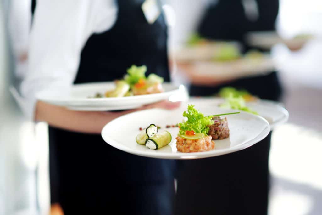 Waiter Carrying Plates With Meat Dish On Some Festive Event 