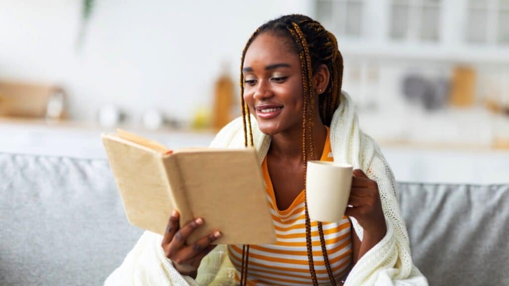 Woman Having Coffee And Reading Book