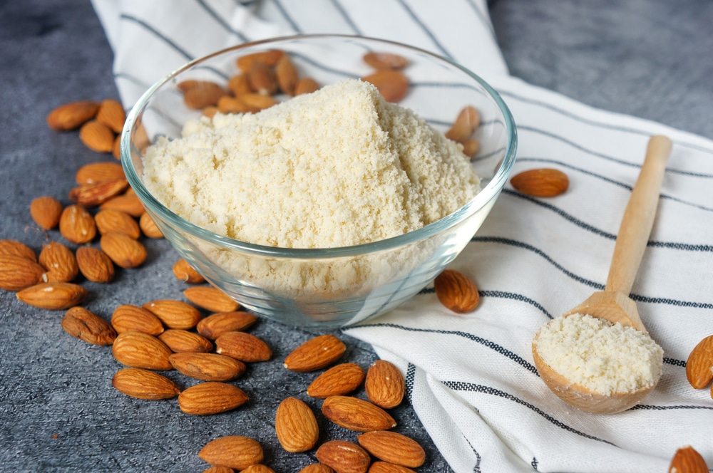 Fresh Almond Flour In A Glass Bowl And Almonds On